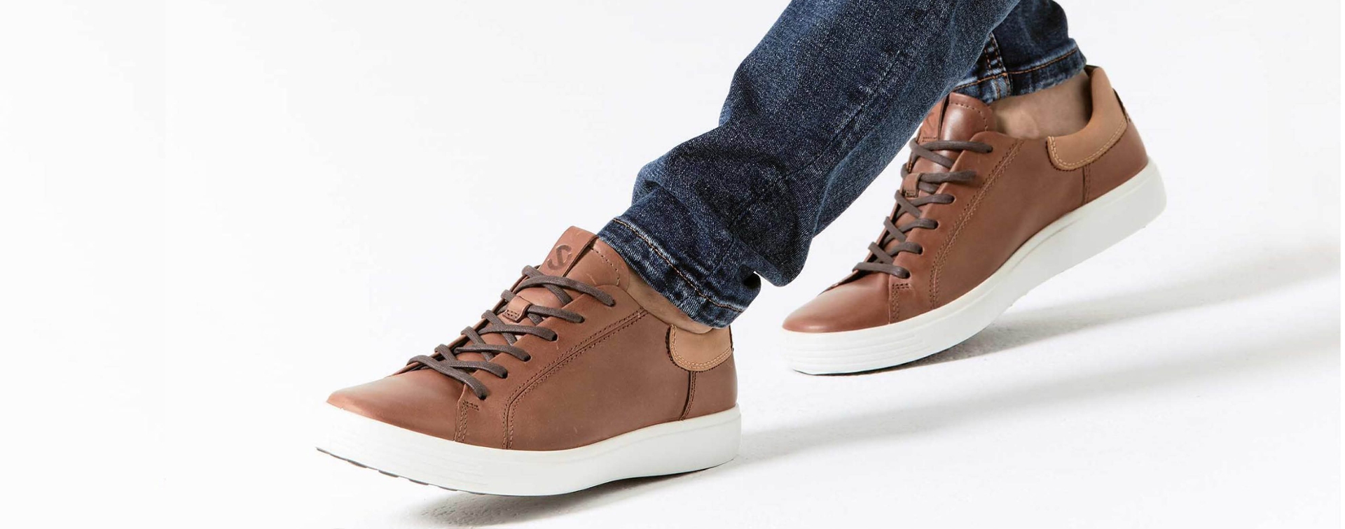 close up of brown leather sneaker on the foot.